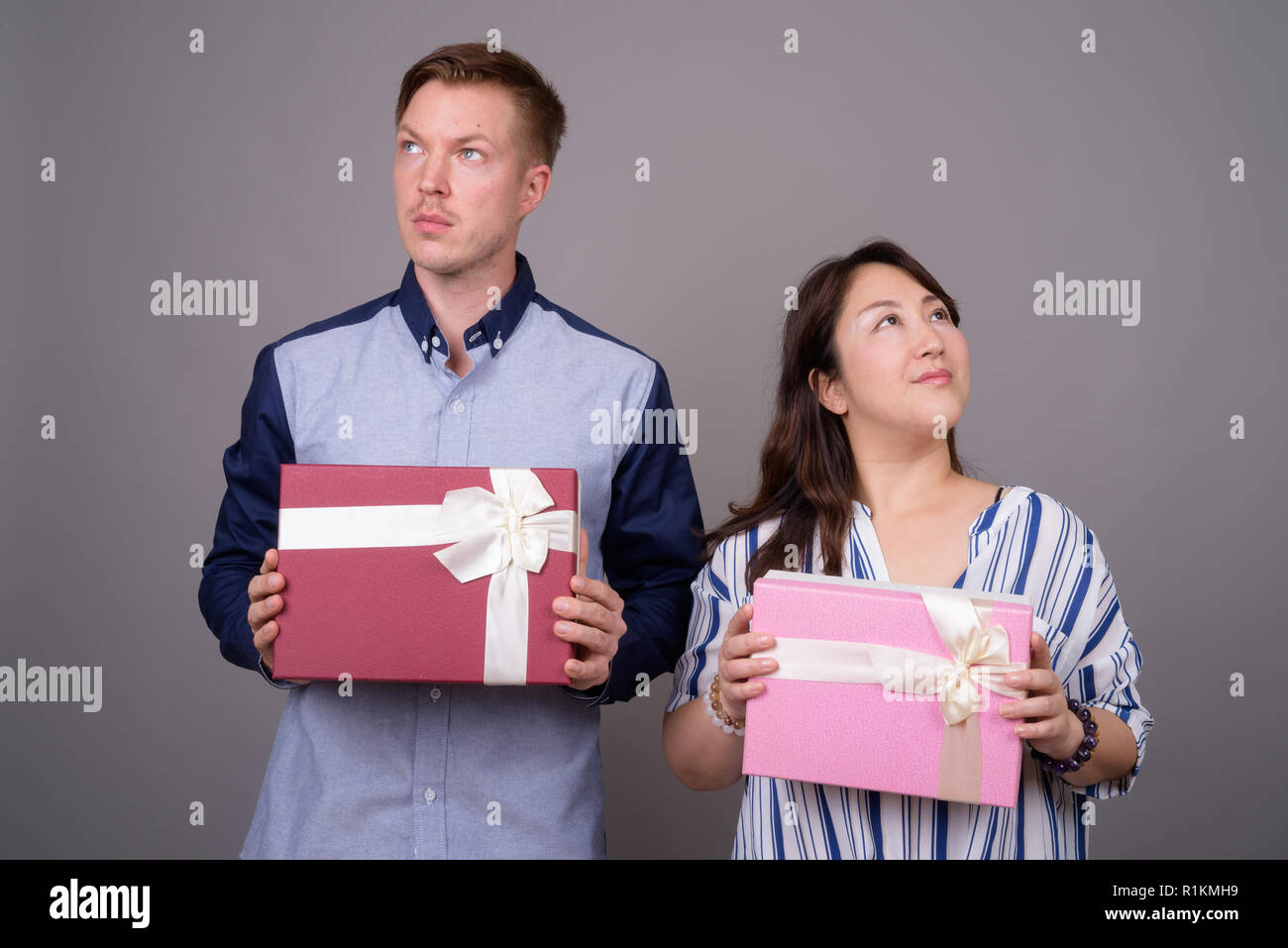 Businessman et mature Asian businesswoman holding gift box Banque D'Images