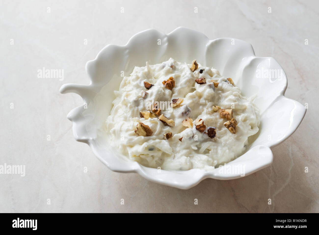 Salade de céleri avec du yaourt et des noix en forme de feuille d'exposition. L'alimentation biologique. Banque D'Images