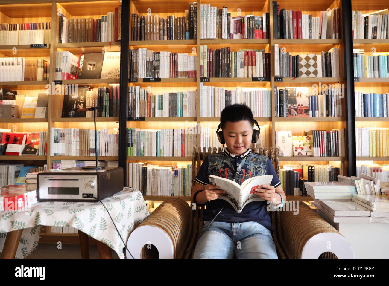 Beijing, Chine. 5 Août, 2018. Un enfant lit un livre dans une librairie à Chongqing, au sud-ouest de la Chine, le 5 août 2018. Des données de l'Administration de la presse et de publication (NPPA) montre que la Chine a connu une croissance rapide de son industrie de l'édition au cours des quatre dernières décennies, avec le nombre de maisons d'édition, passant de 105 à plus de 580. Les librairies physiques en Chine ont pris le chemin du développement intégré et de la transformation et de la mise à niveau, grâce à des politiques mises en place ces dernières années. Credit : Wang Quanchao/Xinhua/Alamy Live News Banque D'Images