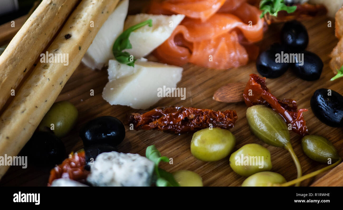 Assiette de fromage avec du saumon, citron, pain et stcks olivas Banque D'Images