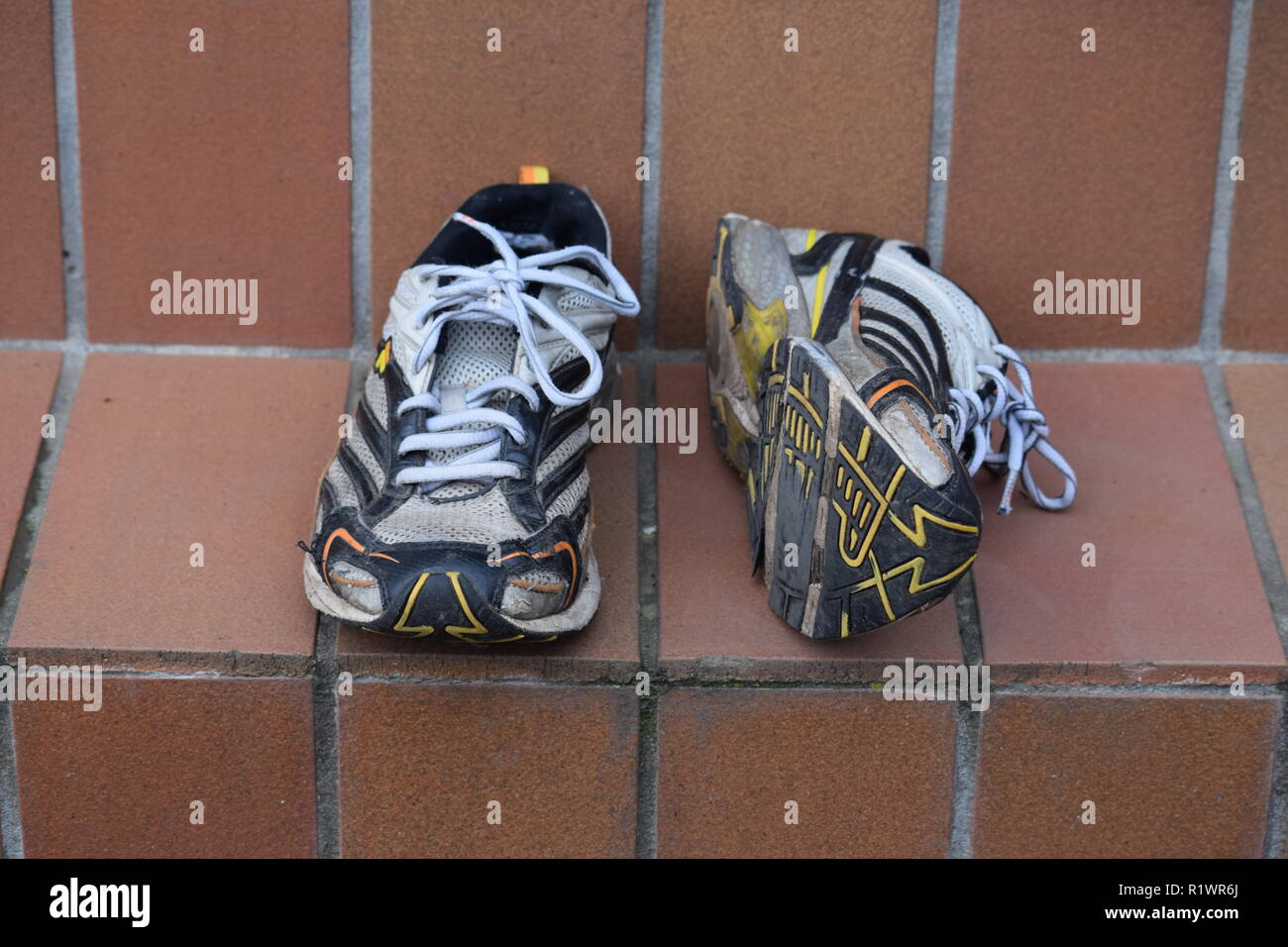 Vieille paire de chaussures de marche et de course usés et avec des trous sous la semelle. Paar- und Lauf alte und mit Löchern Wanderschuhe abgenutzt unter der Sohle Banque D'Images