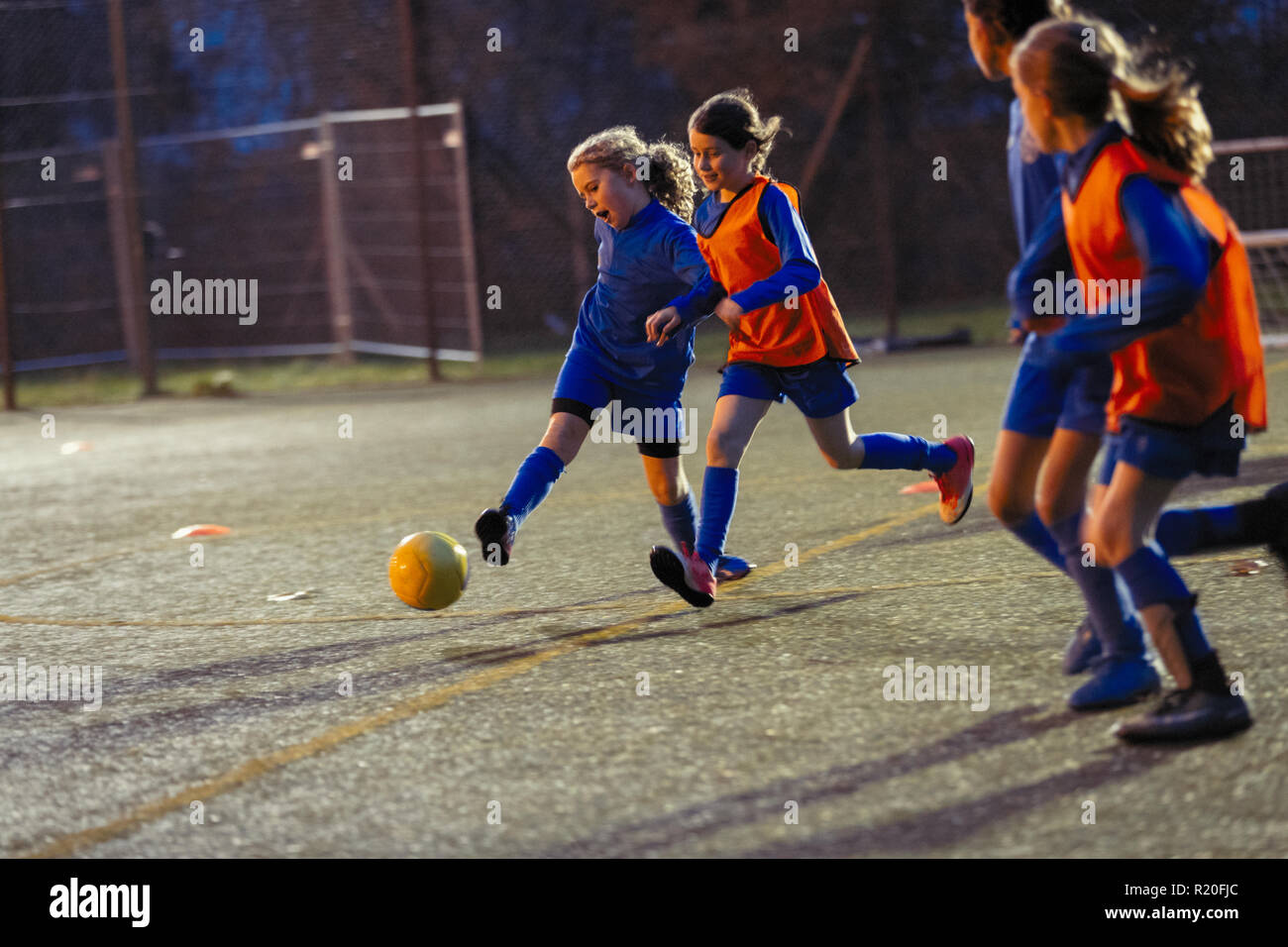 L'équipe féminine de soccer pratiquer sur terrain de nuit Banque D'Images