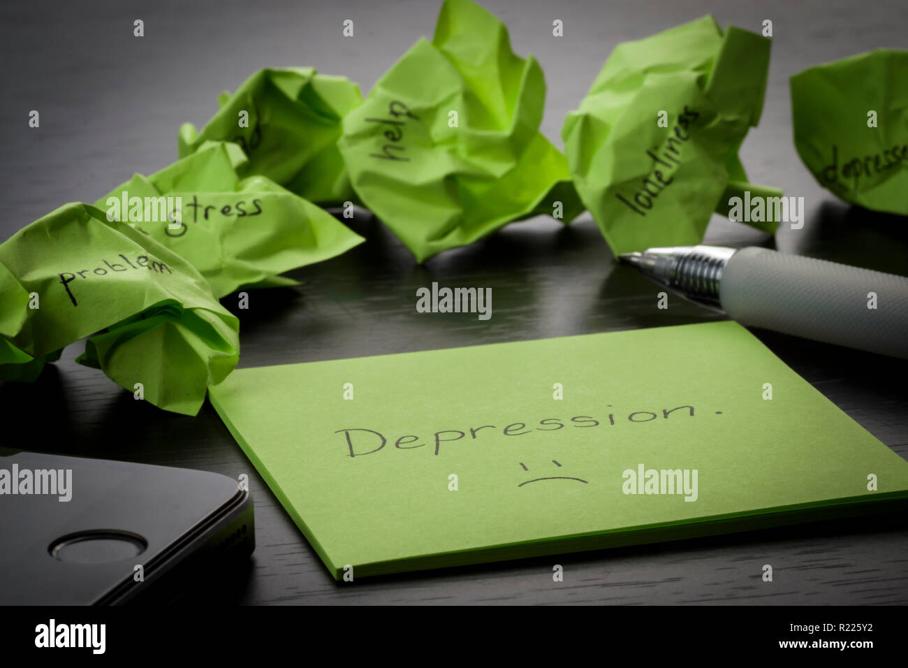La dépression. Le terme "Dépression" est écrit sur les post-it sur le tableau noir en bois. Vert froissé les notes sont dispersés avec des textes écrits Banque D'Images
