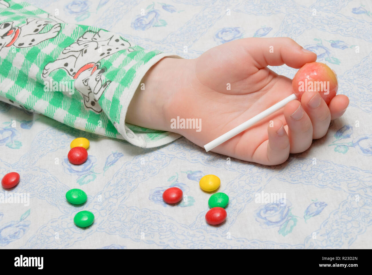 Main d'un petit garçon qui s'était endormi avec des bonbons dans ...