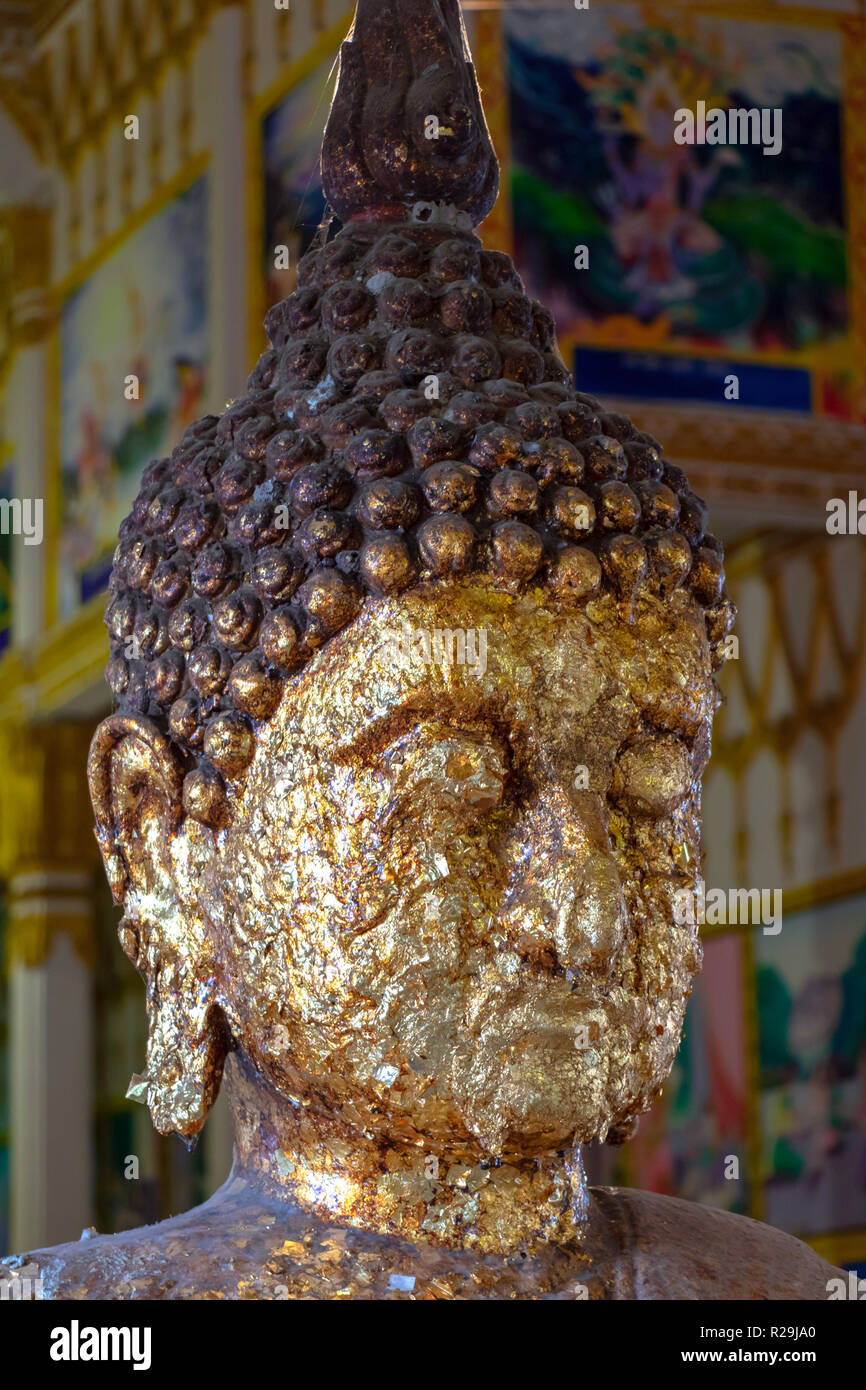 Le portrait de Bouddha de pétales dorés à l'intérieur de temple bouddhiste en Thaïlande. Feuille d'or sur la statue de Bouddha. Banque D'Images