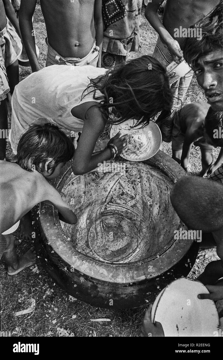 81/37 centre d'aide aux victimes des inondations, dirigées par des jeunes de l'aile partie Jinjira BNP . Enfants gratter le dernier repas du pot 1980 Banque D'Images