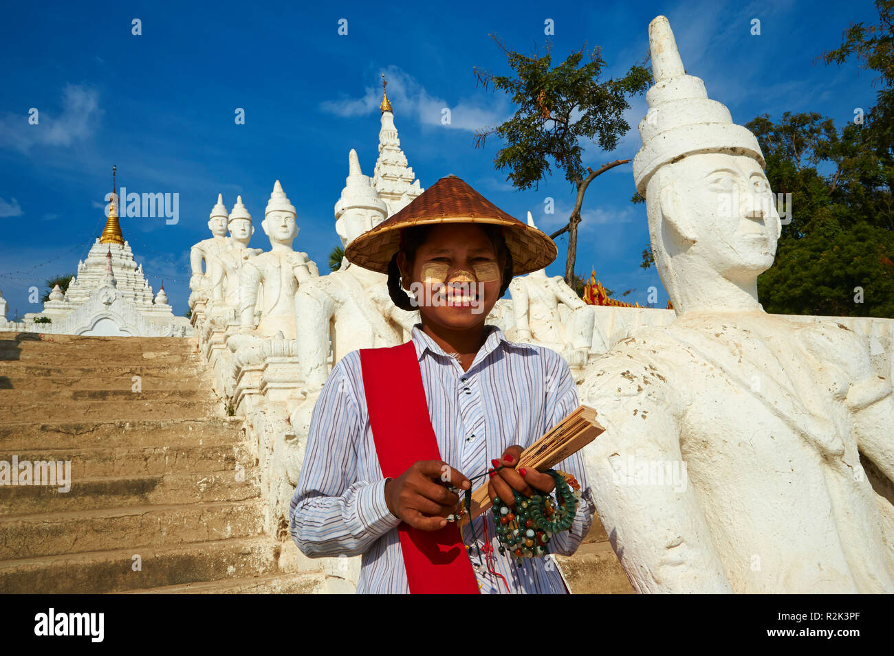 Jeune femme à côté de statues de Bouddha, le Myanmar, l'Asie, Banque D'Images