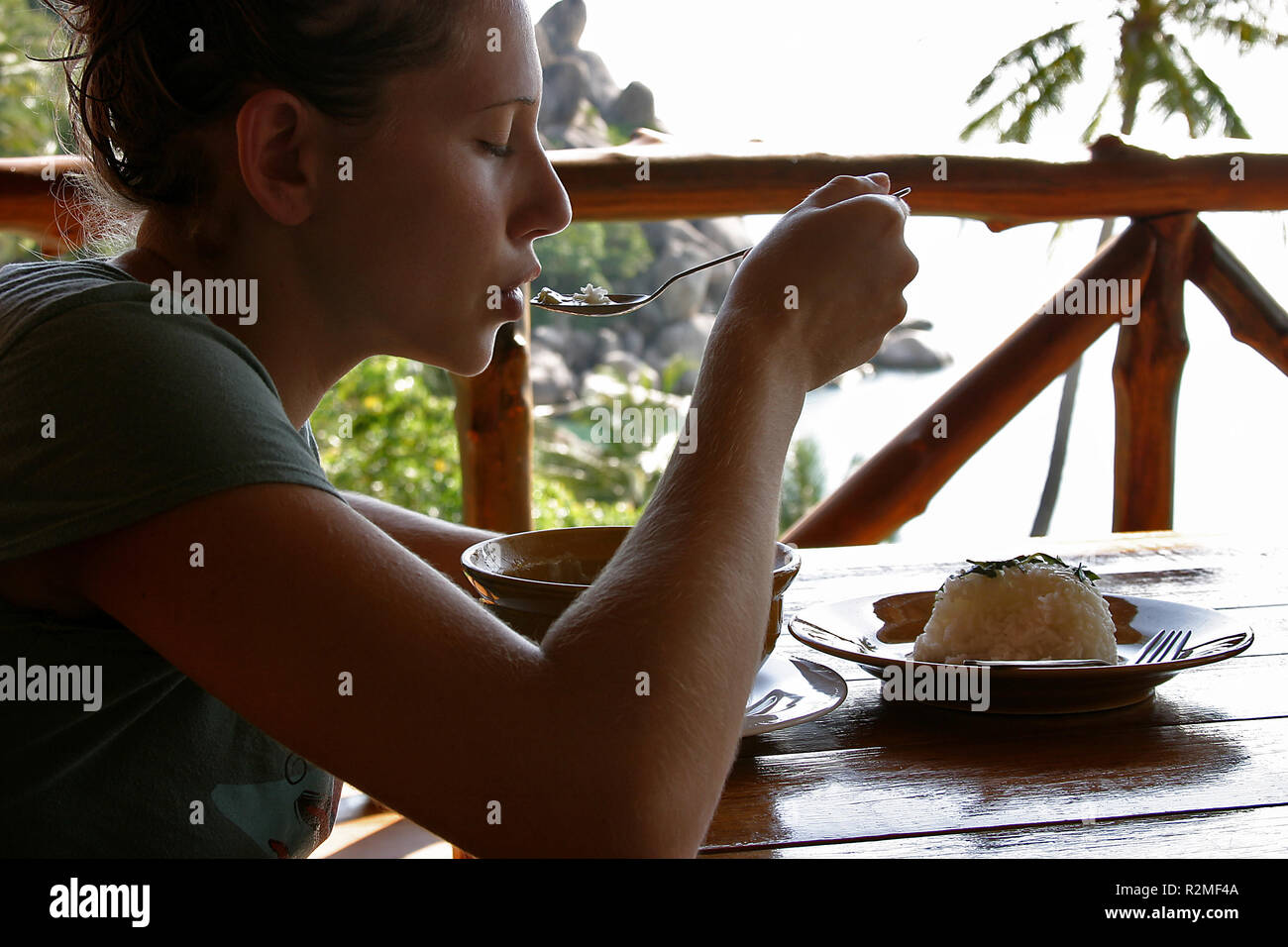 Femme aime manger sur la terrasse en face de la mer Banque D'Images