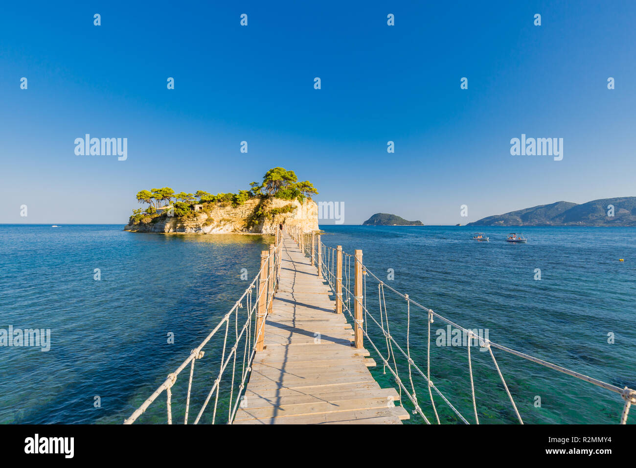 Pont en bois de Agios Sostis menant à une petite île rocheuse. Baie de Laganas, l'île de Zakynthos, Grèce. Banque D'Images