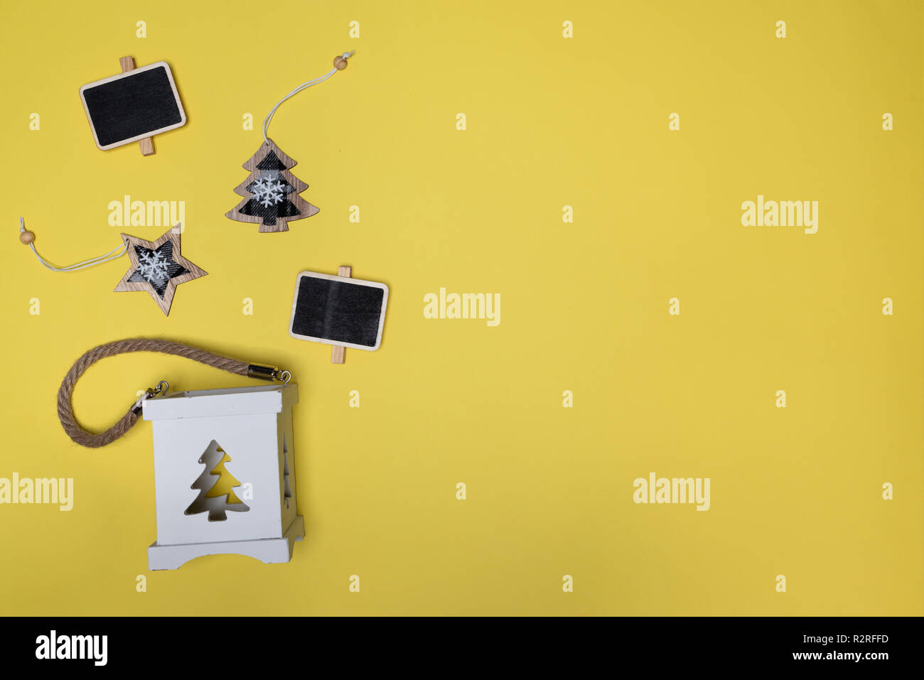 Star, arbre de Noël, un mini tableau en bois et support bougie. Mise à plat contre l'arrière-plan jaune with copy space Banque D'Images