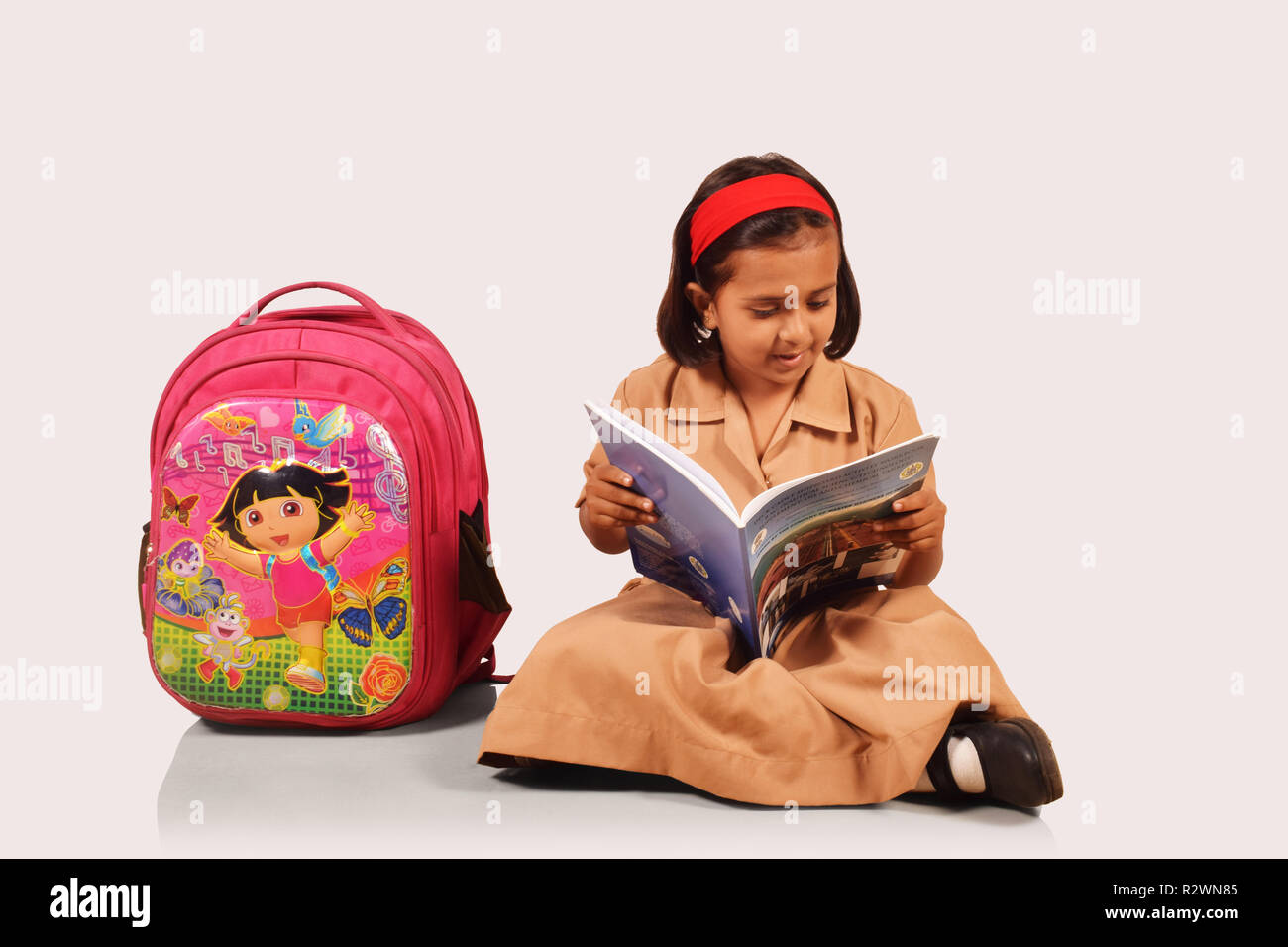 Petite fille en uniforme d'étudiant avec sac d'école sur le côté. Pune, Maharashtra Banque D'Images