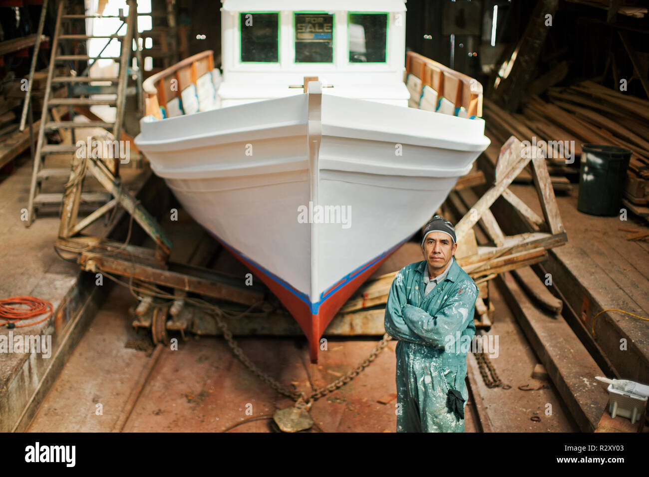 Portrait of a middle aged man standing in front of an incomplete bateau. Banque D'Images