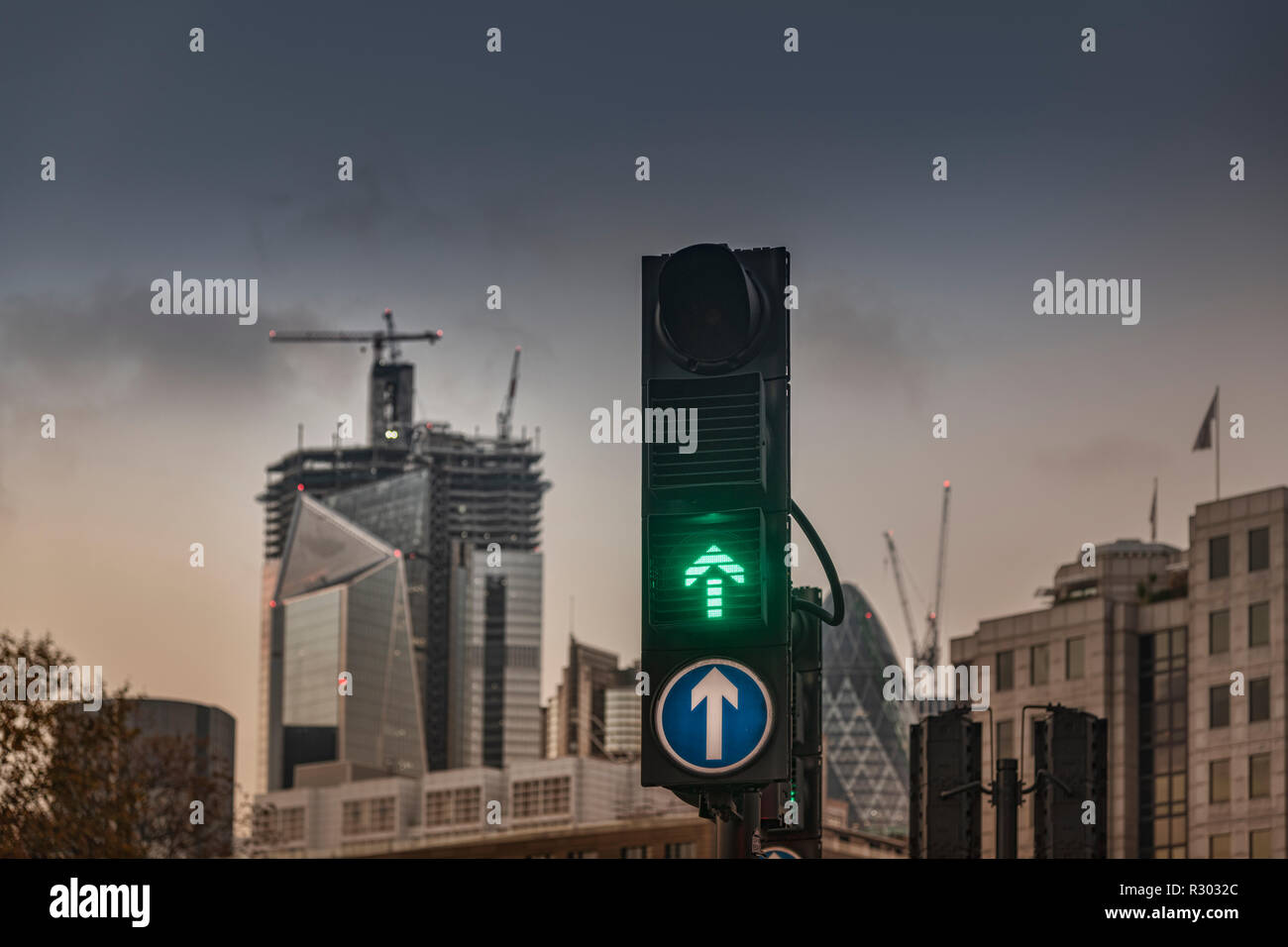 Feu vert et tout droit, flèche vers le haut avec de grands édifices de la ville et du site de construction dans la ville de Londres Banque D'Images