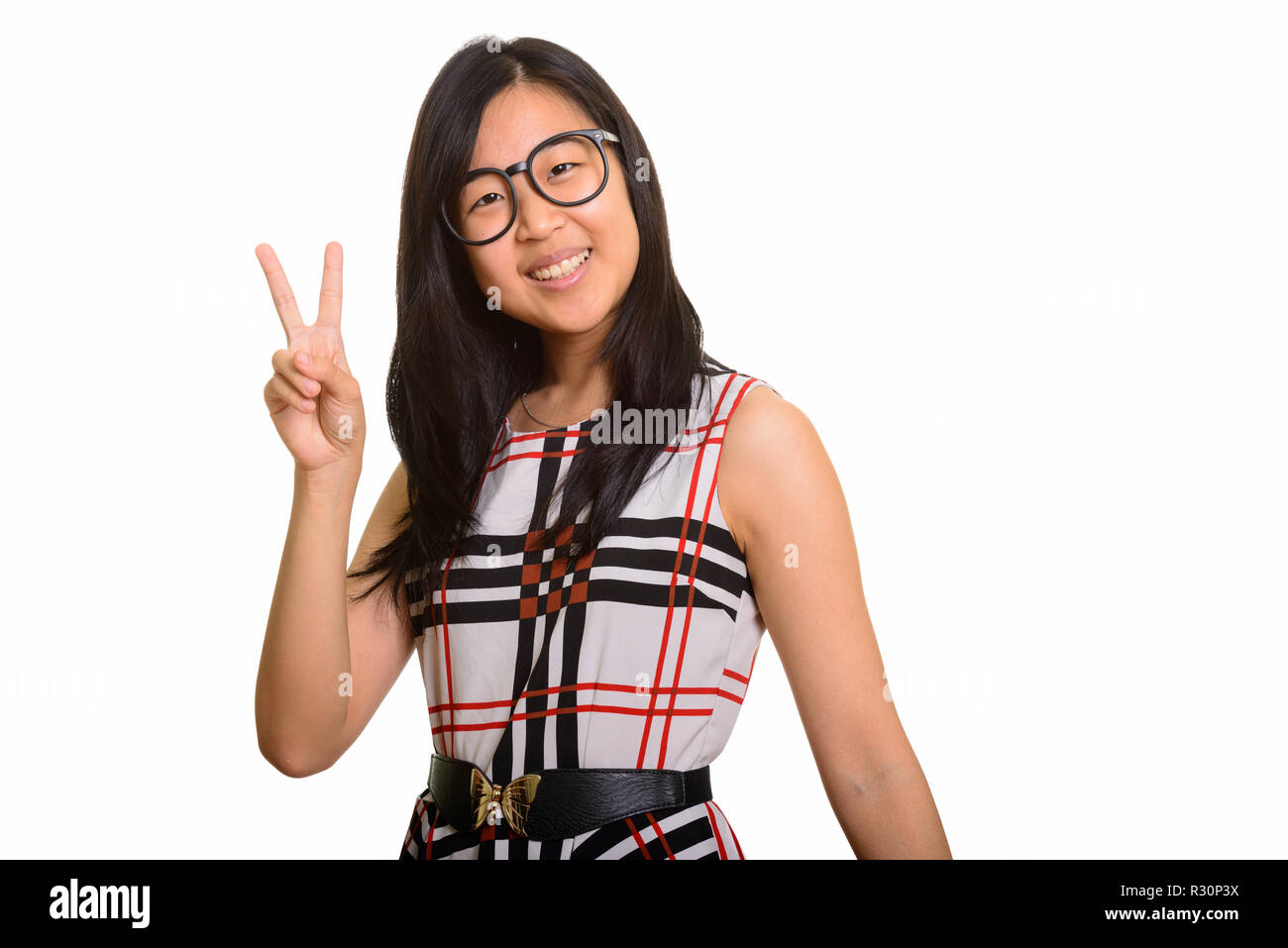 Young happy Asian businesswoman giving peace sign Banque D'Images