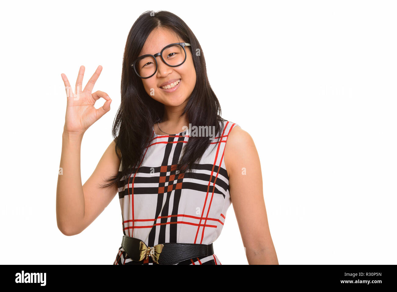 Young happy Asian businesswoman giving ok sign Banque D'Images