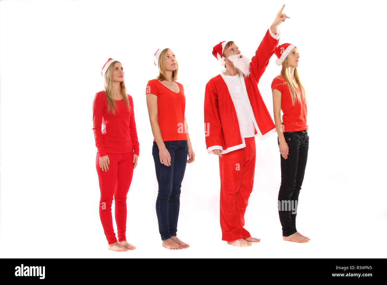 Groupe de personnes en costumes de Noël regardez en l'air Banque D'Images