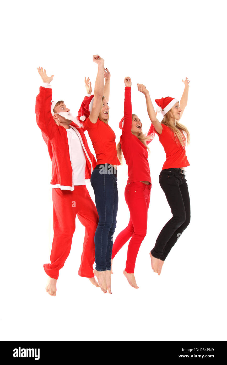 Groupe de personnes en costumes de Noël sautant en l'air Banque D'Images