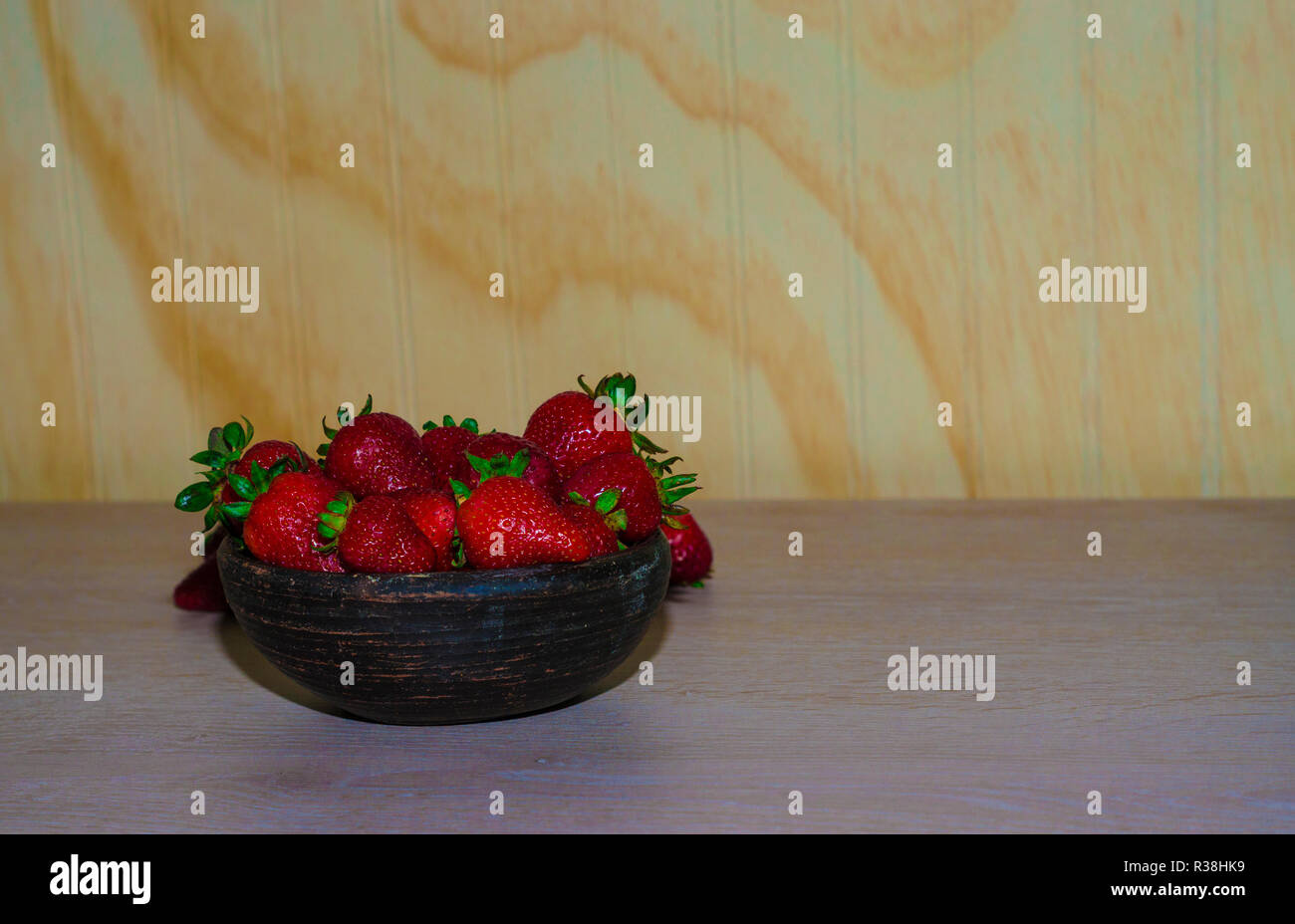 Fresas rojas y maduras frescas sobre vasija de greda Banque D'Images