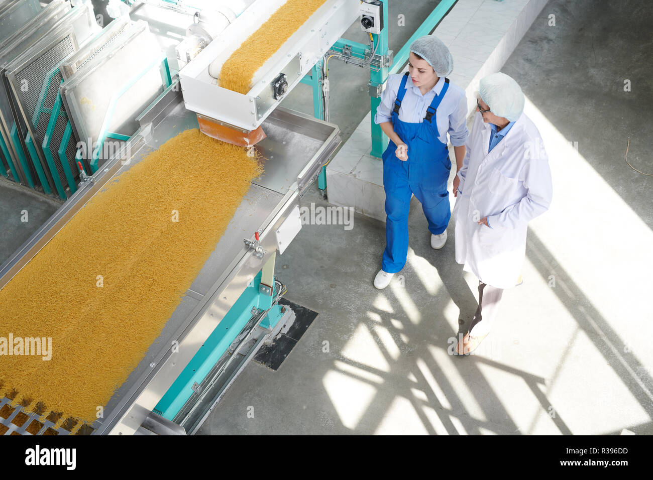 Deux travailleurs à l'arrière-plan de l'usine alimentaire Banque D'Images