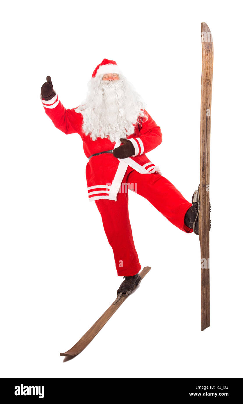 Funny Santa Claus se dresse sur un vieux rétro et de ski réussie montre thumb up geste, isolé sur fond blanc. Santa sportives sur d'anciennes salutation Banque D'Images
