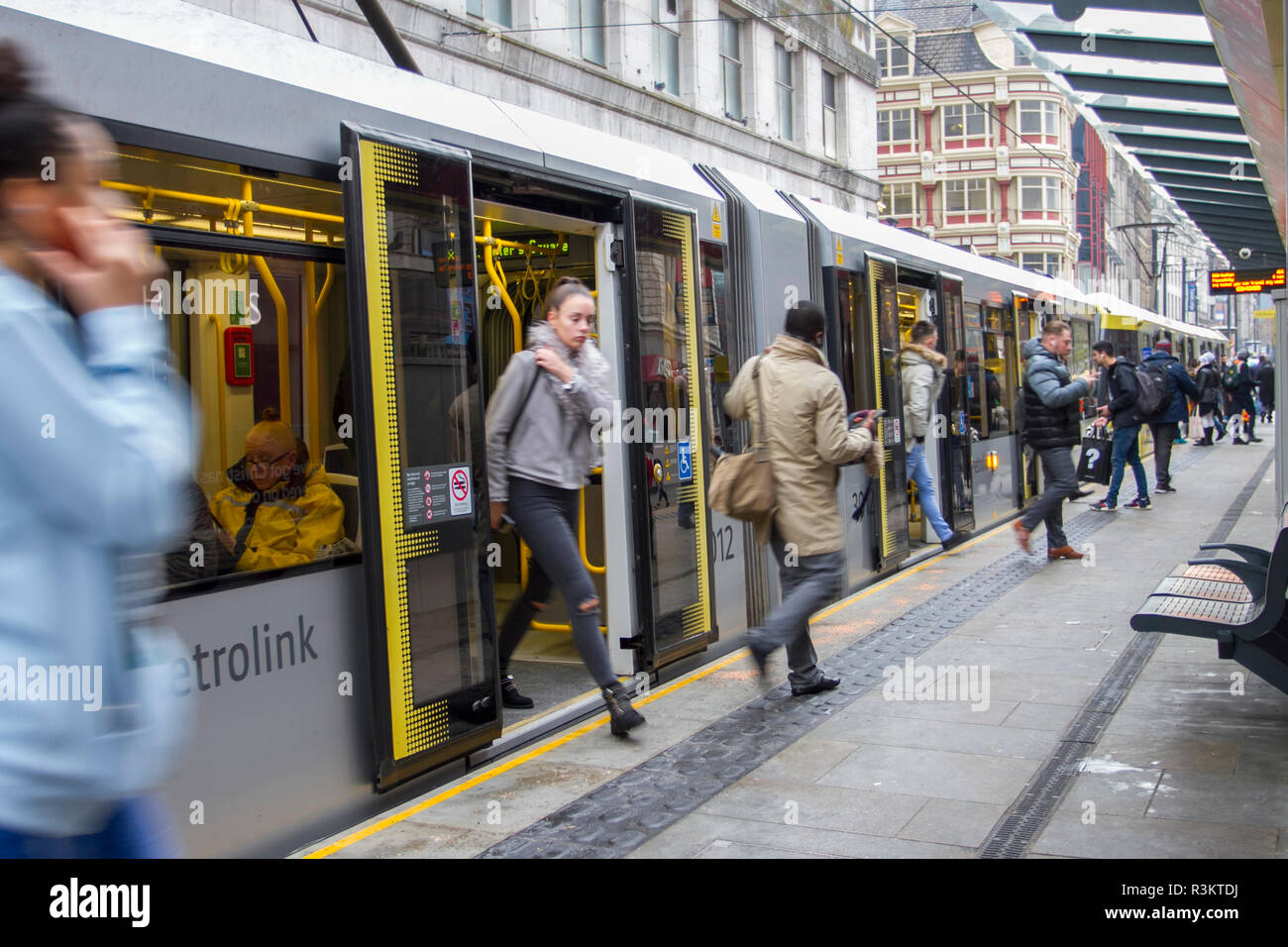 Manchester, UK. 23 novembre, 2018. Les clients arrivant par tramway MetroLink sur Noir Vendredi Fin de semaine chargée des ventes. Centre-ville de magasinage des fêtes, boutiques, magasins, shopping de Noël, vente discount shopping, femme les dépenses de consommation pour les week-end vendredi noir considéré comme le plus grand événement commercial de l'année. Les détaillants britanniques ont adopté le style USA vente bonanza, avec de nombreux clients laissés surprendre par négocier des rabais, bénéficiant d'un noël dépensent et transportant un certain nombre des sacs, des cadeaux, des cadeaux et des éléments de vente. /AlamyLiveNews MediaWorldImages : crédit. Banque D'Images