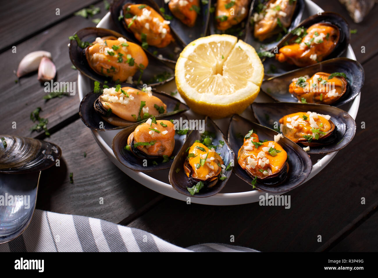 Les moules cuites. Les moules cuites à la vapeur dans une sauce au vin blanc avec le persil et l'ail. De savoureux fruits de mer espagnol recette. Close up Banque D'Images