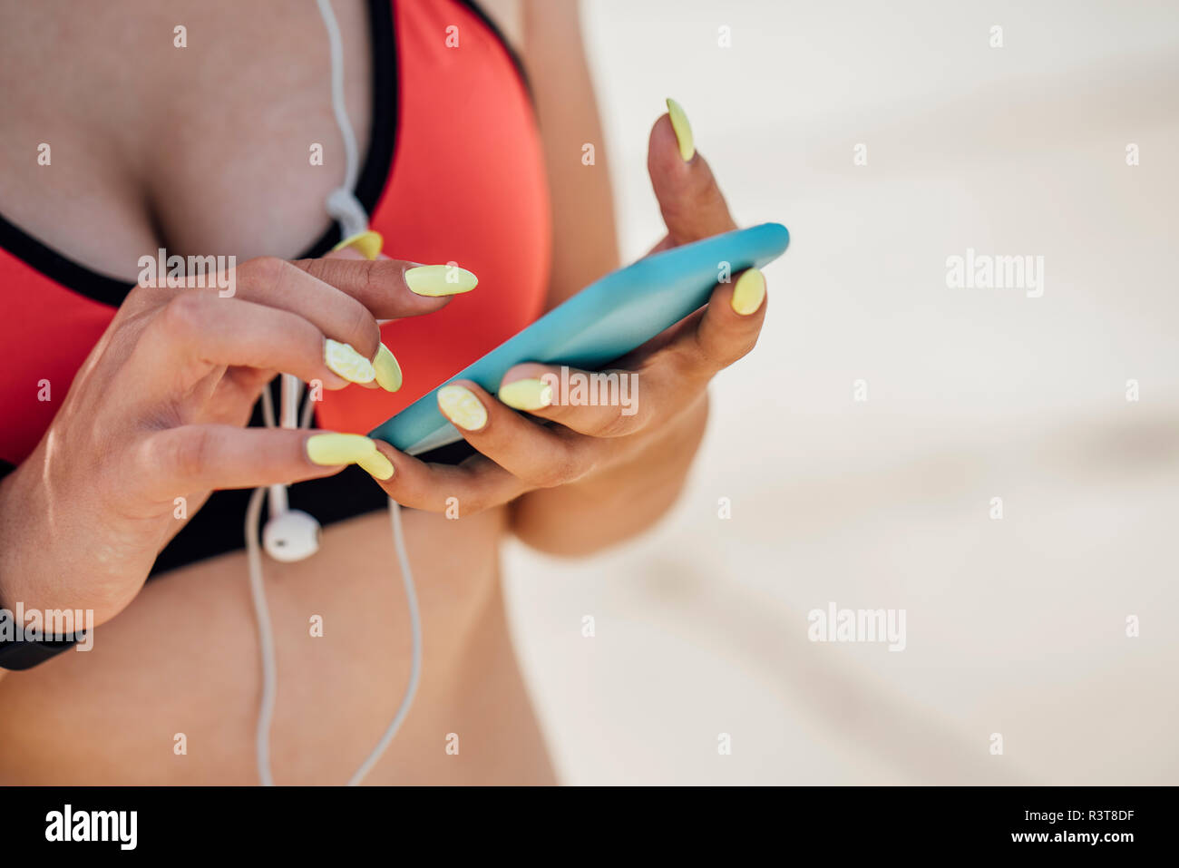 Close-up of young woman wearing bra using smartphone Banque D'Images