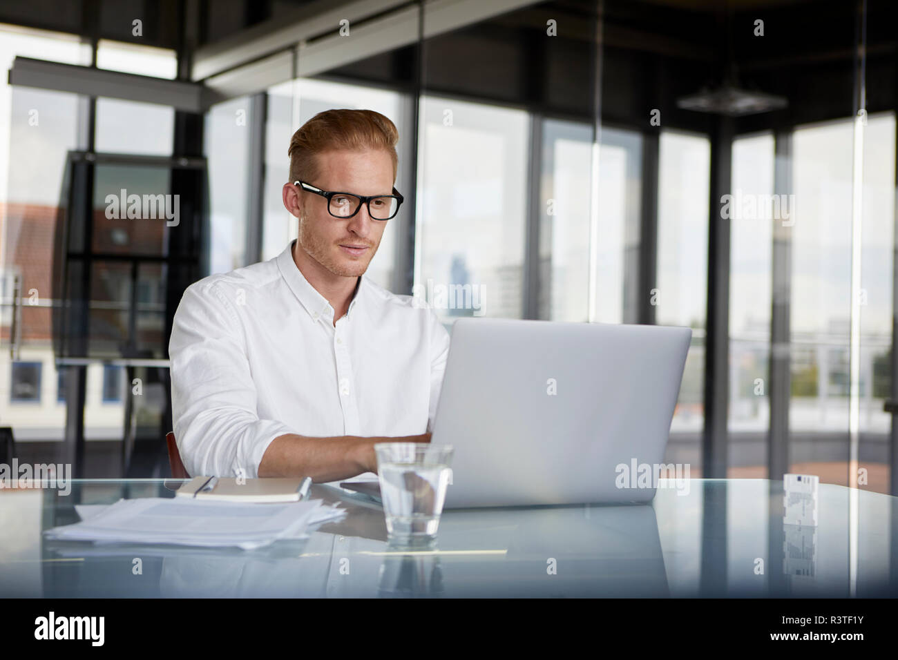 Businessman using laptop on desk in office Banque D'Images
