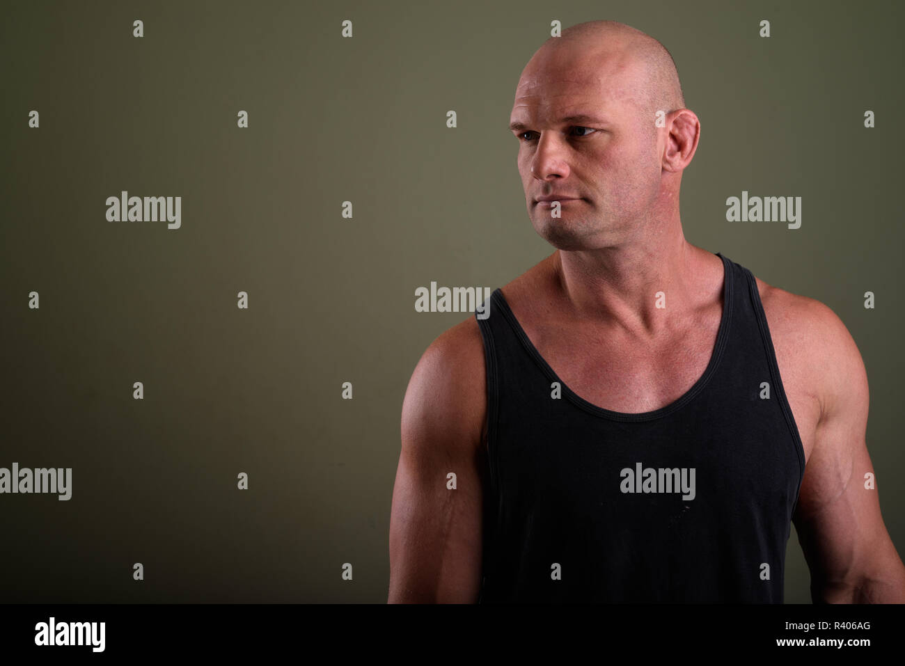 Bald man wearing tank top musclé contre l'arrière-plan de couleur Banque D'Images
