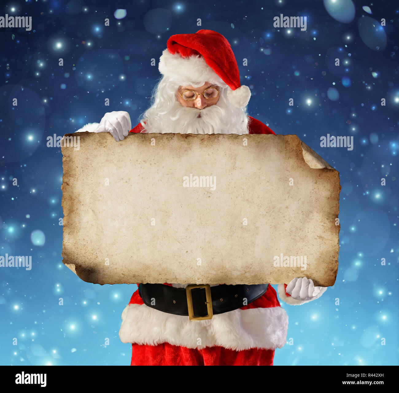 Santa Claus Reading Liste de souhaits dans la nuit enneigée Banque D'Images