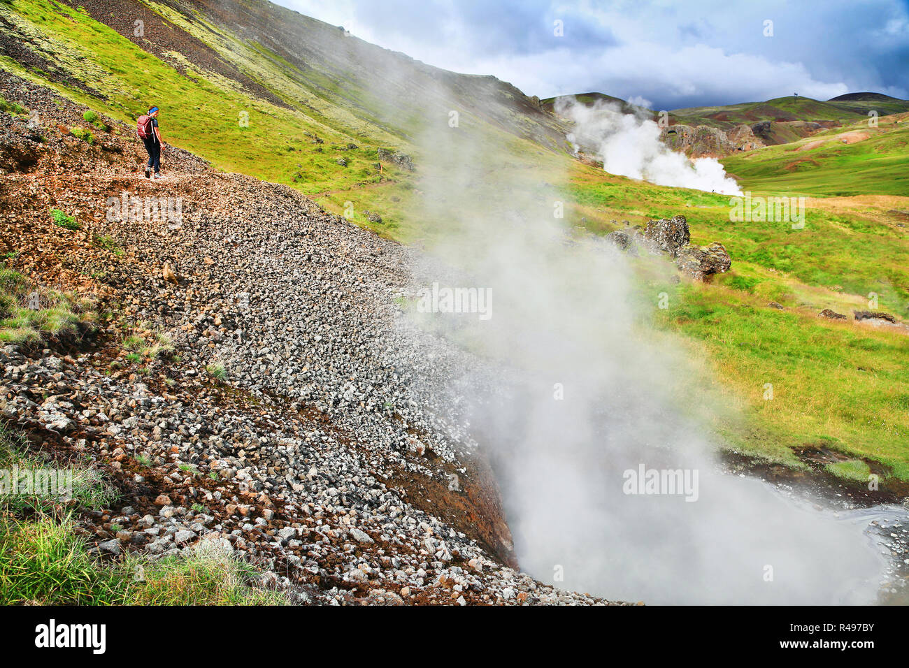 Sur le sentier de randonnée femme dans de beaux paysages le long de l'énergie géothermique des geysers à Hveravellir, Islande Banque D'Images