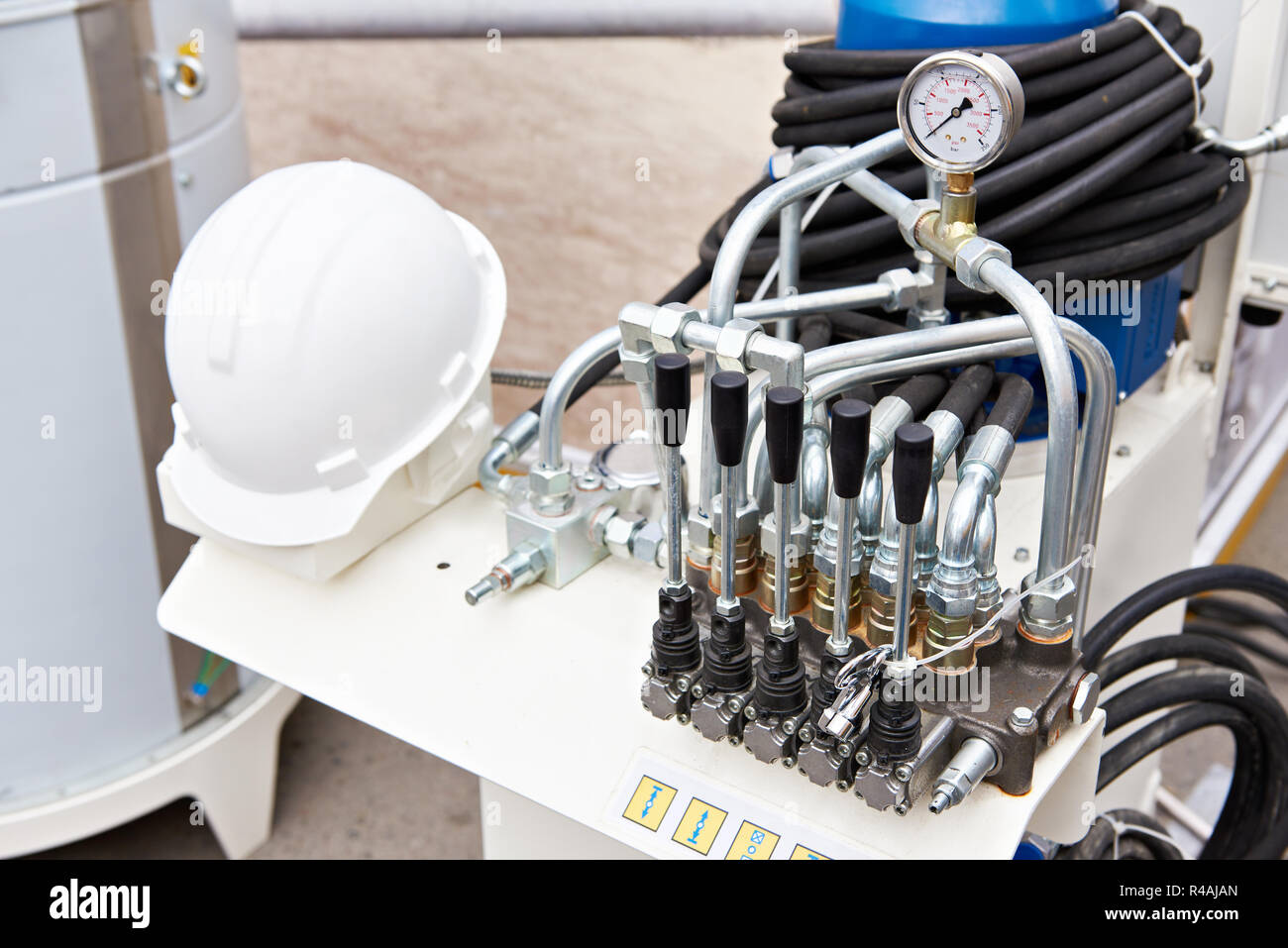 Soupapes de commande d'équipement hydraulique et casque de construction Banque D'Images