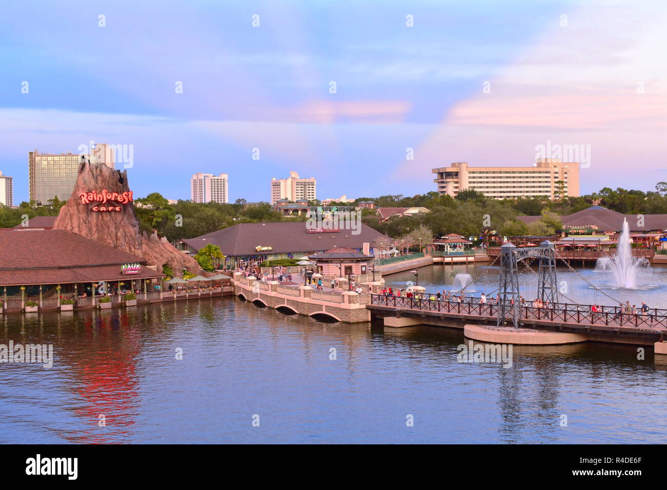 Orlando, Floride. 15 novembre 2018 Vue panoramique de volcan, vintage bridge et hôtels sur le coucher du soleil avec rayons magenta de Lake Buena Vista Banque D'Images