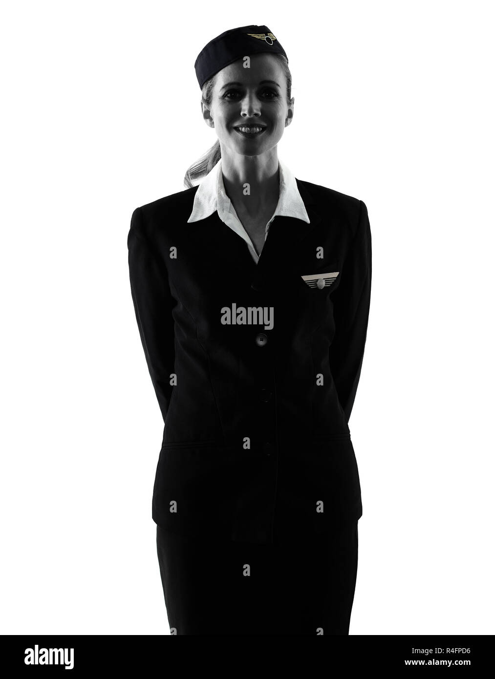 Une hôtesse de l'équipage de cabine de race blanche femme debout isolé sur fond blanc en silhouette Banque D'Images