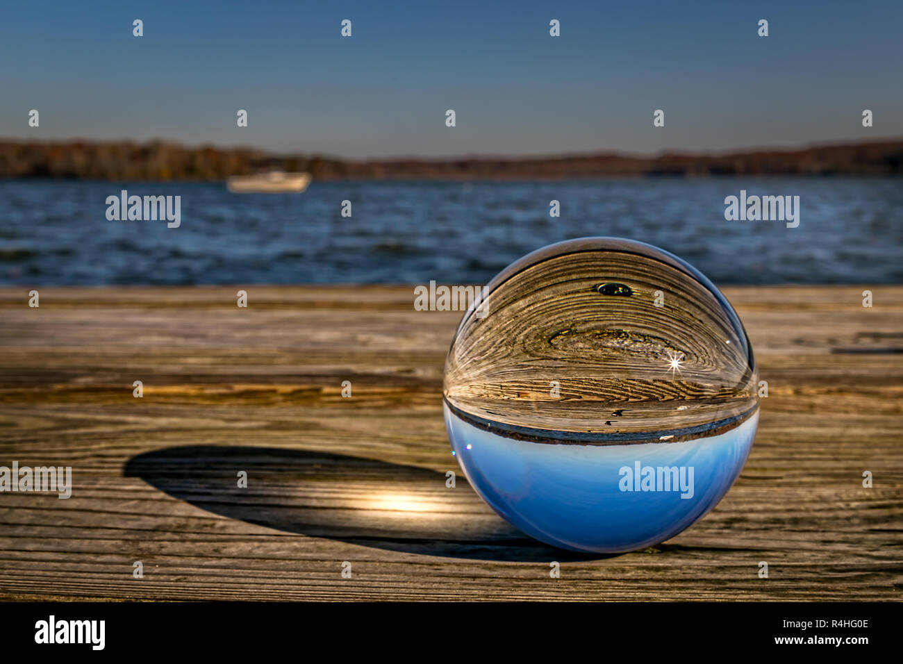 Une photo en verre ball assis sur un quai en bois à Virginia reflétant le soleil du matin. Banque D'Images