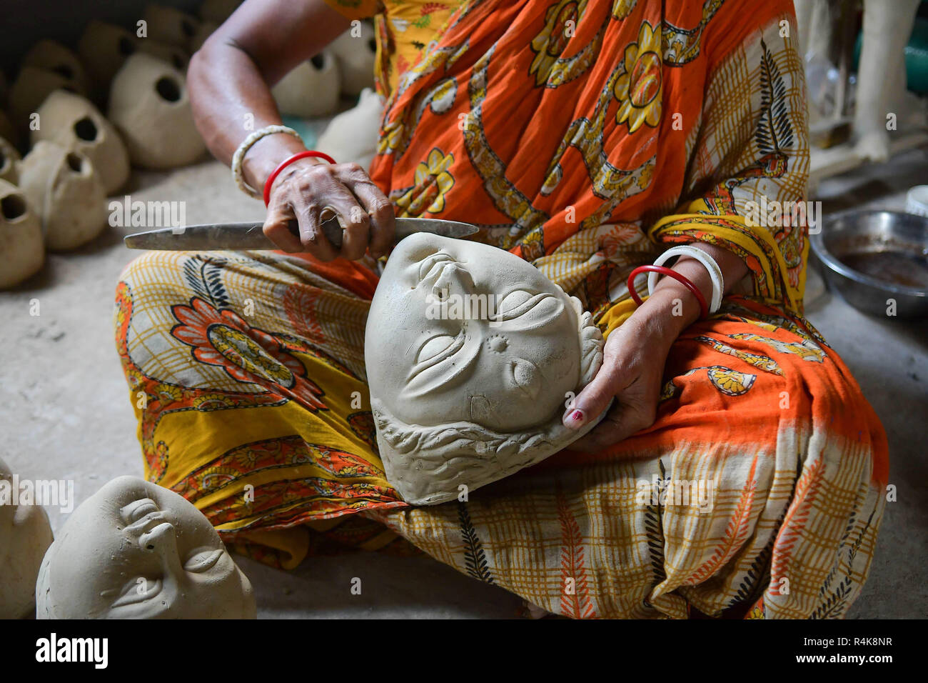 Un artiste indien vu préparation de l'argile idol visages de déesses Durga, l'avant de la Durga Puja festival à l'intérieur d'un studio à Agartala. Durga Puja, le festival hindou annuel qui implique l'adoration de la déesse Durga, qui symbolise la puissance et le triomphe du bien sur le mal dans la mythologie hindoue, culmine dans l'immersion du corps des idoles dans l'eau. Banque D'Images