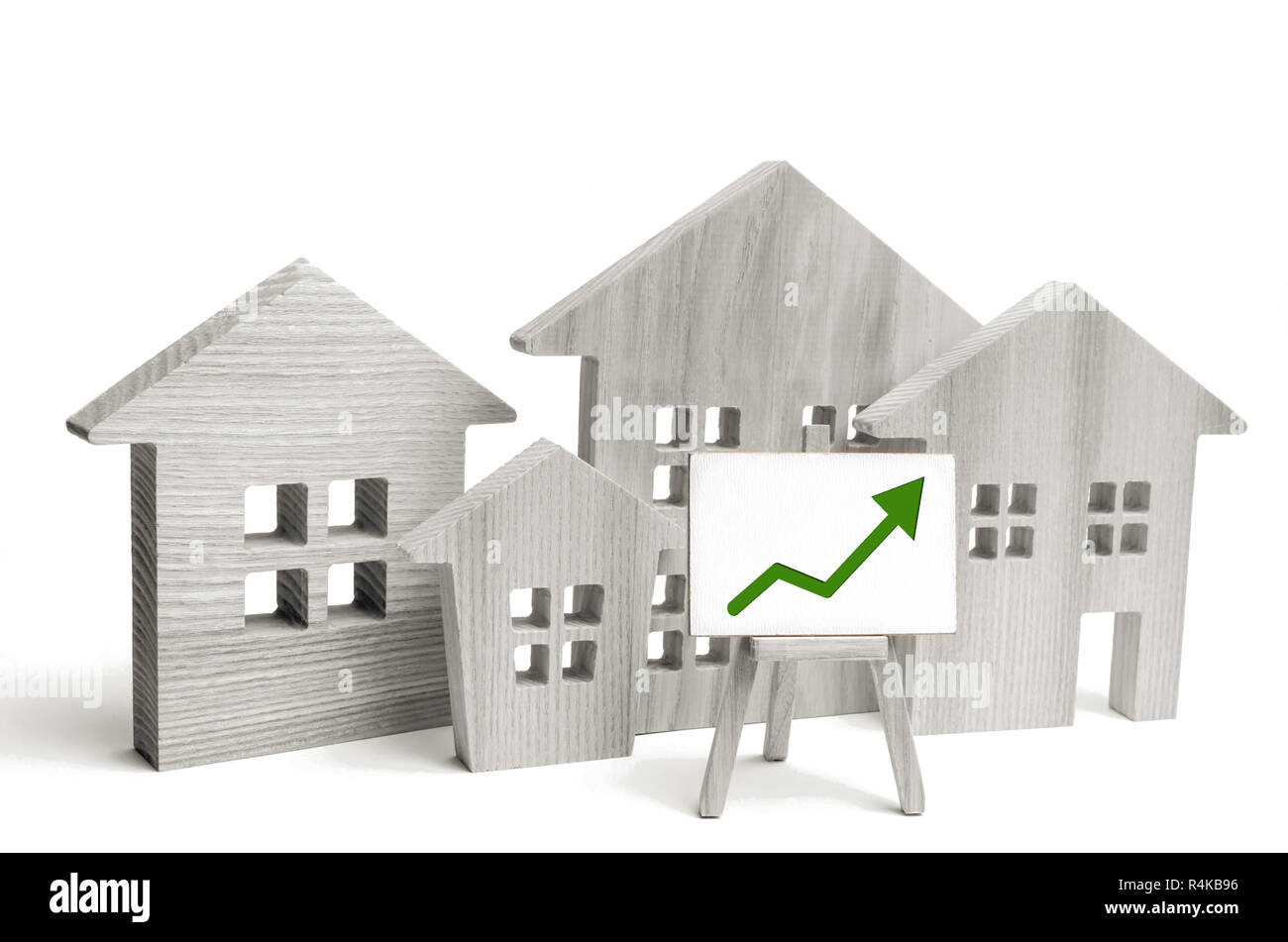 Maisons en bois avec une flèche verte. concept de forte demande pour l'immobilier. accroître l'efficacité énergétique du logement. hausse des prix de l'immobilier. propriété. po Banque D'Images
