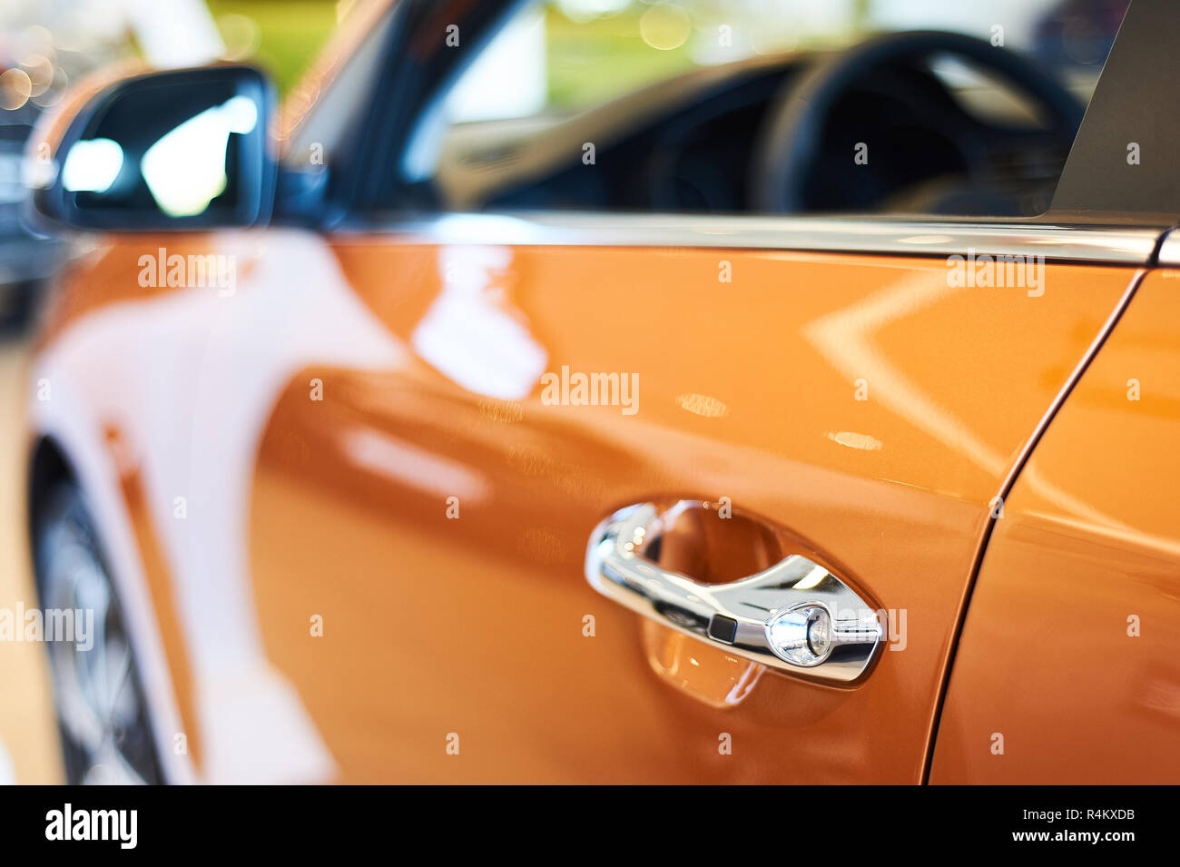 Poignée métallique chromé de nouvelle voiture orange libre. auto car showroom Banque D'Images