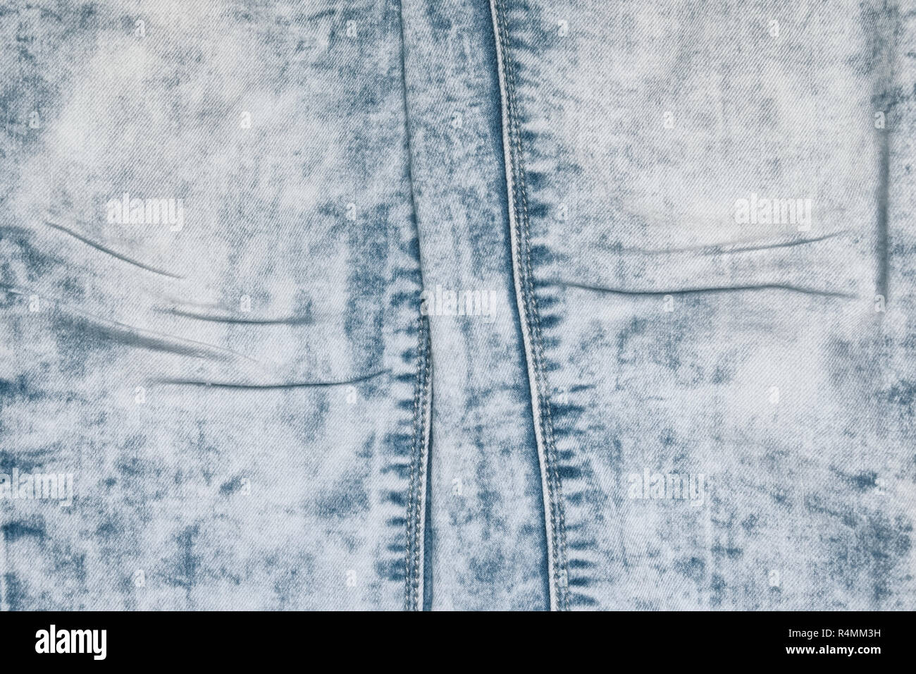 Jeans délavés acides avec plis sur un tour de denim Banque D'Images