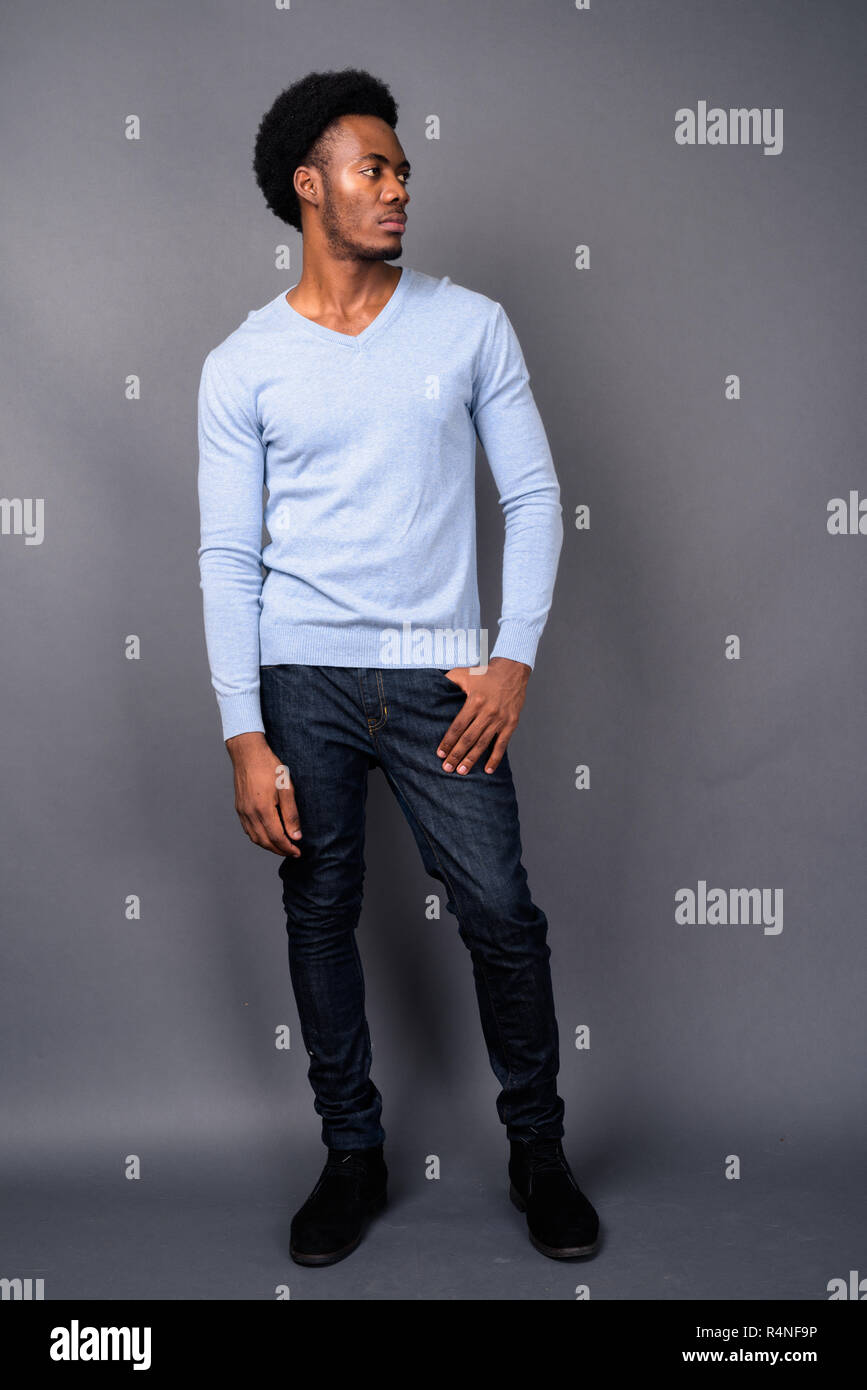 Beau jeune homme africain contre l'arrière-plan gris Banque D'Images