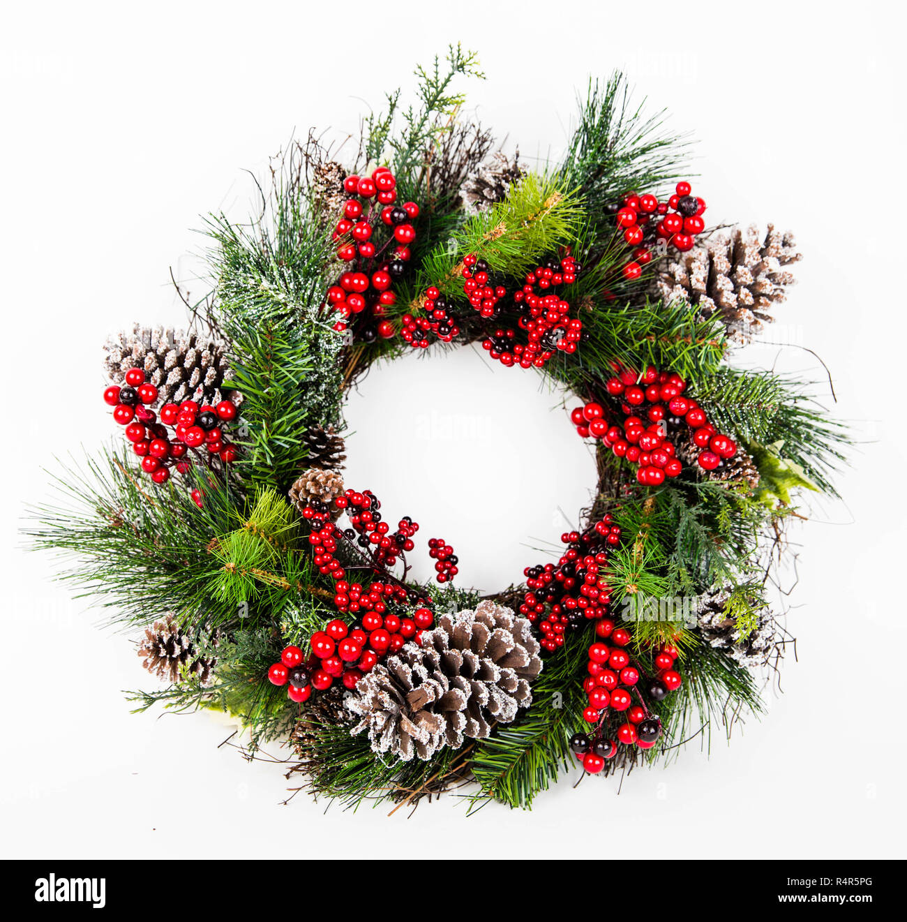 Couronne de noël faites de branches de Pins à la recherche naturaliste décorées avec des baies d'hiver et des pommes de pin Banque D'Images