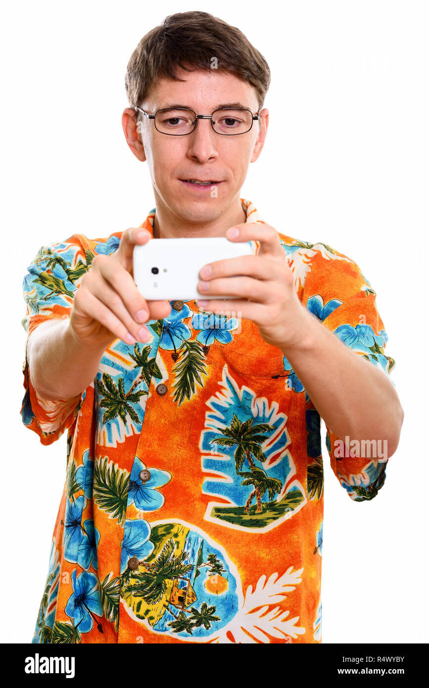 Studio shot of man taking picture with mobile phone Banque D'Images