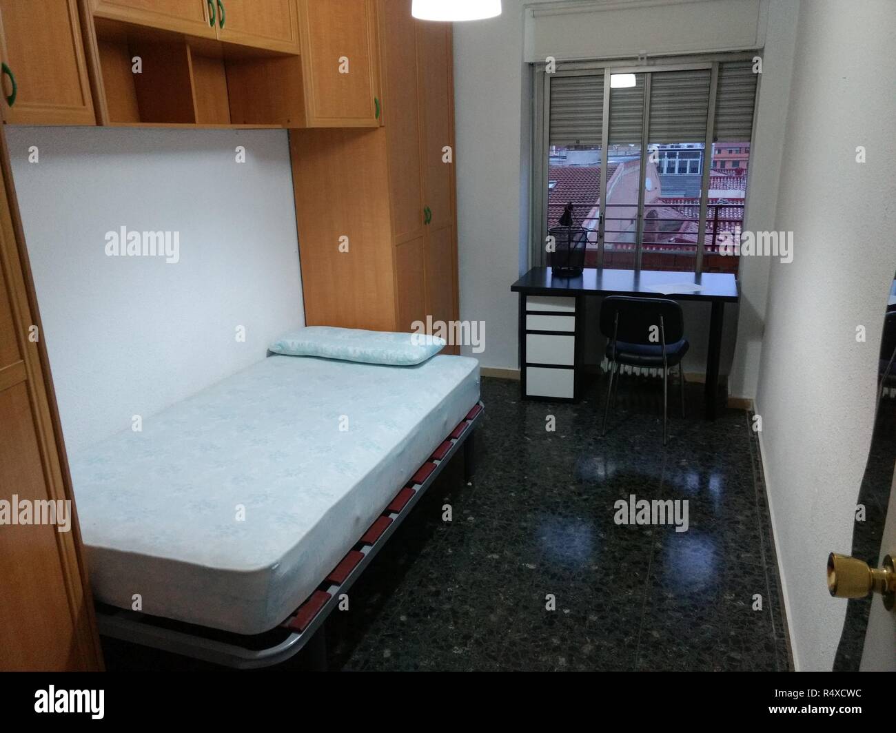 Plat vide une chambre avec un lit double, armoire pont noir et blanc, un  bureau, une chaise et un étage à Saragosse, Espagne Photo Stock - Alamy