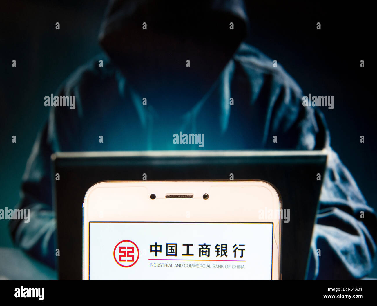 Multinationale chinoise voyage société industrielle et commerciale de Chine (ICBC) logo est vu sur un appareil mobile Android avec une figure de hacker dans l'arrière-plan. Banque D'Images