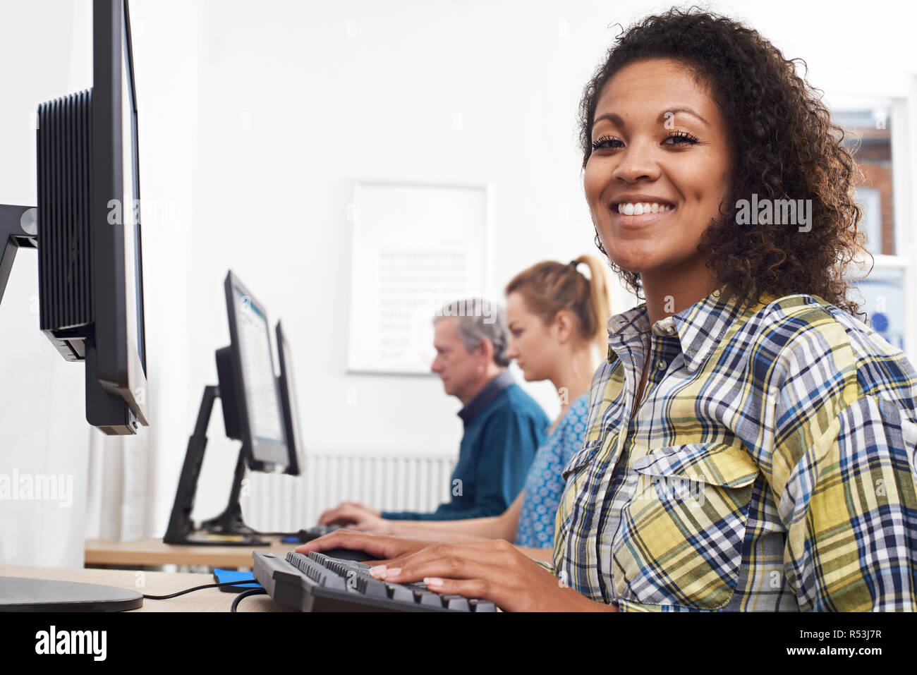 Portrait de Jeune femme participant à la classe de l'ordinateur en face de l'écran Banque D'Images