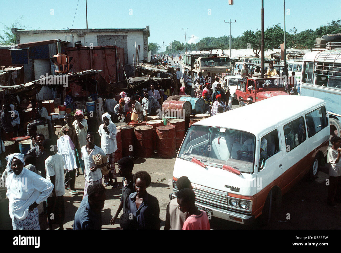 1992 - Les gens et les véhicules foule un coin de rue au cours de l'effort de secours multinationales l'Opération Restore Hope. Mogadiscio (Somalie) Banque D'Images