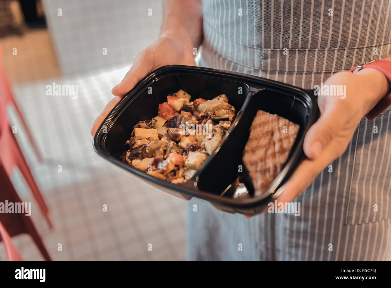 Port serveur main rouge watch holding box avec une commande de client Banque D'Images