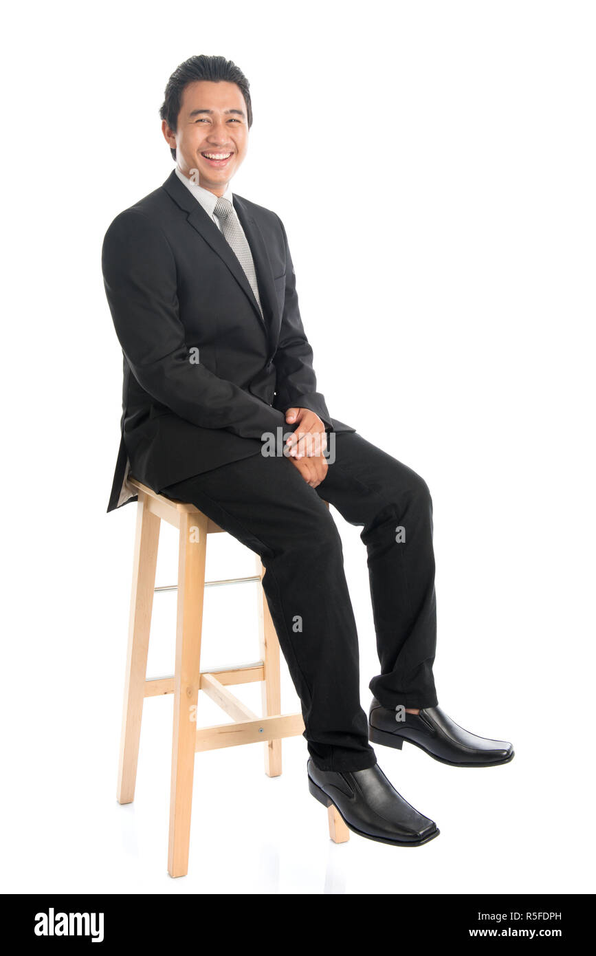 Corps complet Asian businessman assis sur la chaise haute Banque D'Images