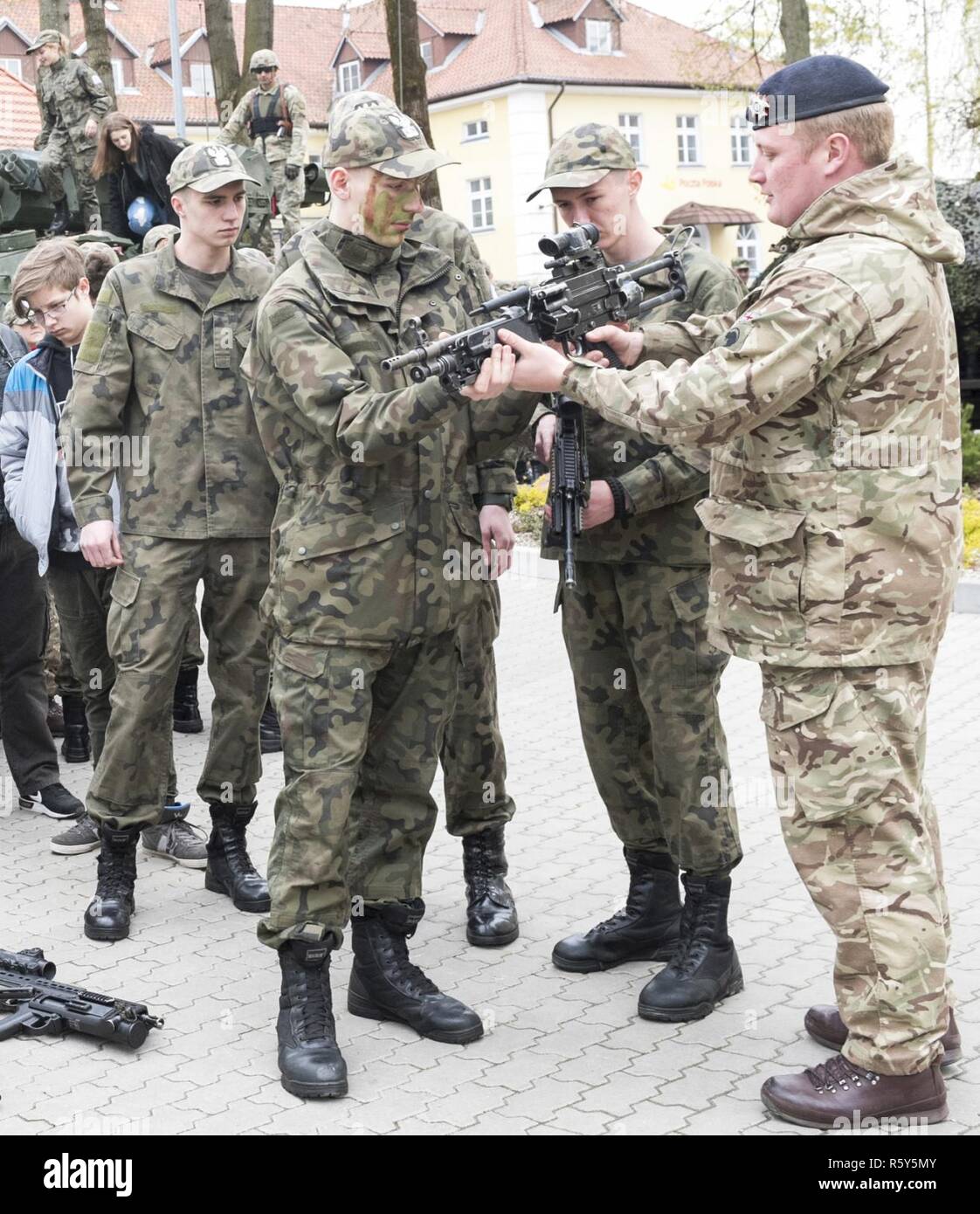 Un soldat britannique de Battle Group Pologne montre aux étudiants sa mitrailleuse de 5,56 mm au cours de Journée Portes Ouvertes à l'Stol DOSKONALENIA ZAWODOWEGO, une école militaire, à Gizycko, Pologne 25 avril. Au cours de l'événement, les étudiants et les citoyens polonais ont interagi avec l'unité multinationale et exploré son équipement de combat. L'unique formation d'américains, britanniques et soldats roumains sont en service avec Polish 15e Brigade mécanisée de soldats comme une force de dissuasion dans le nord-est de la Pologne à l'appui de l'OTAN vers l'amélioration de la présence. Banque D'Images