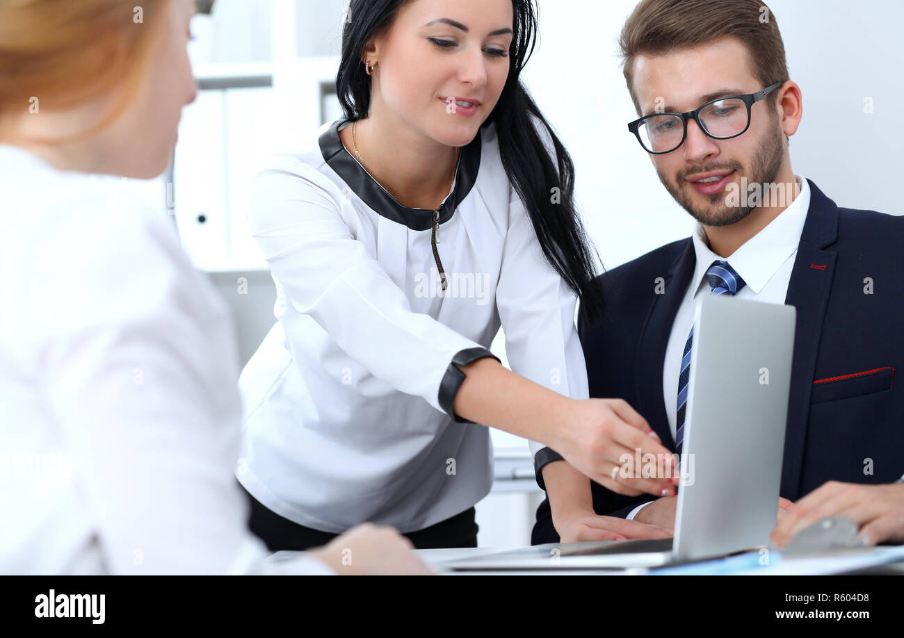 Les gens d'affaires à l'équipe réunie en bureau. L'accent chez business woman pointing en ordinateur portable. Le travail d'équipe ou coaching concepts Banque D'Images